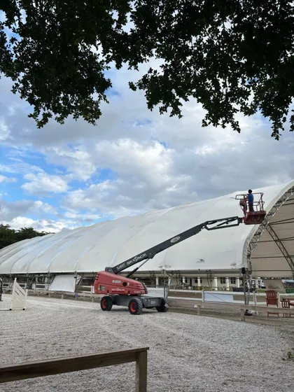 Crew washing a large commercial structure from a boom lift