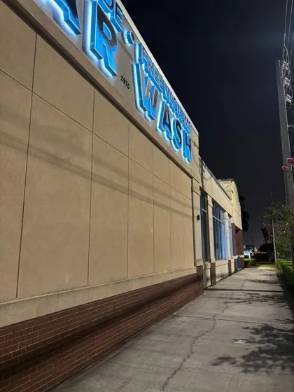 Storefront wall and walkway cleaned at night