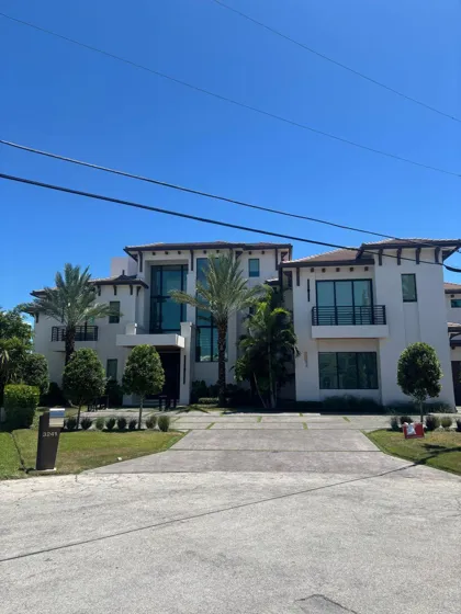 A paver driveway in front of a modern home