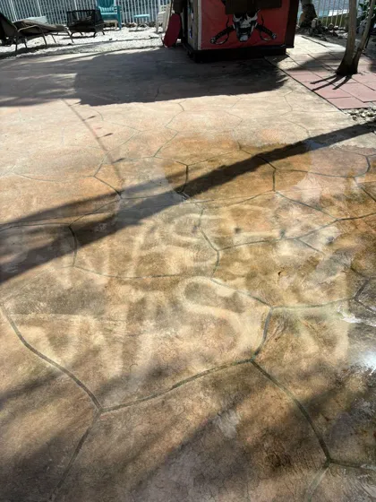 The words WASHY WASHY written into a dirty patio with a pressure washer