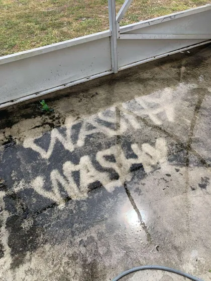WASHY WASHY written into a mildewed pool deck